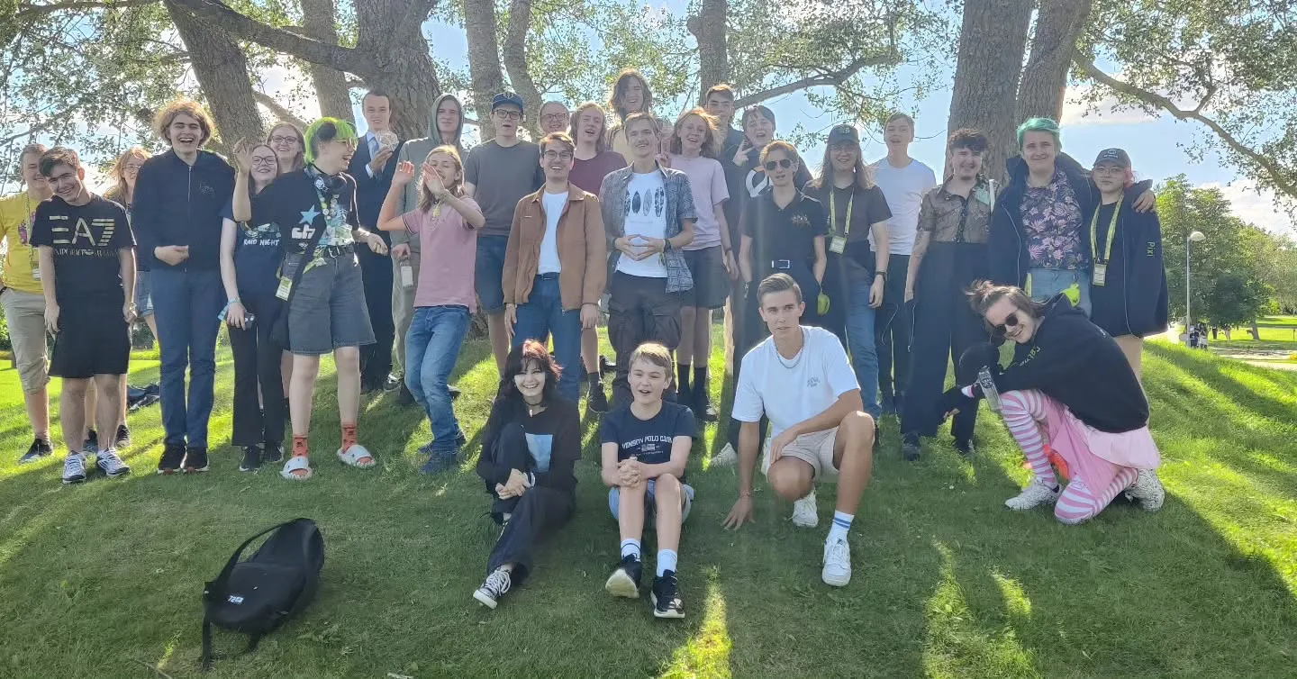Gruppbild på glada SGC-medlemmar utomhus i grönskan